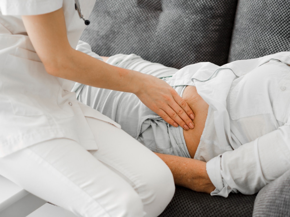 Doctor checking patient with hip bursitis