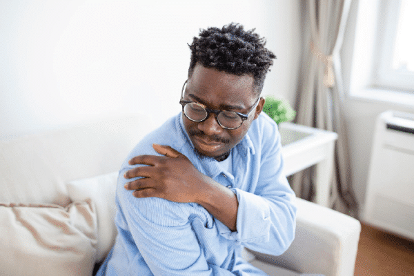 tired man massaging stiff sore neck tensed muscles fatigued from computer work